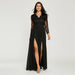 Woman wearing a black lace dress with a slit on a white background