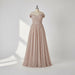 Elegant off-shoulder gown with a high slit on a gray background