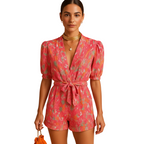 woman wearing printed summer jumpsuit with belted waist shown in full front view outfit