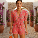 woman wearing printed summer jumpsuit with belted waist shown in full front view outfit