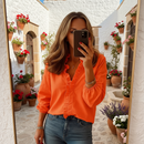 woman wearing ruffle detail blouse with lightweight structure shown in full front view outfit