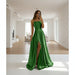 Green evening gown with a slit on a white background