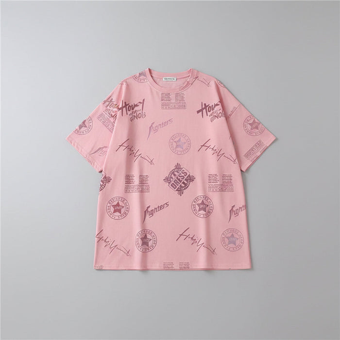Person wearing a pink oversized t-shirt with text and graphic designs in a casual setting.