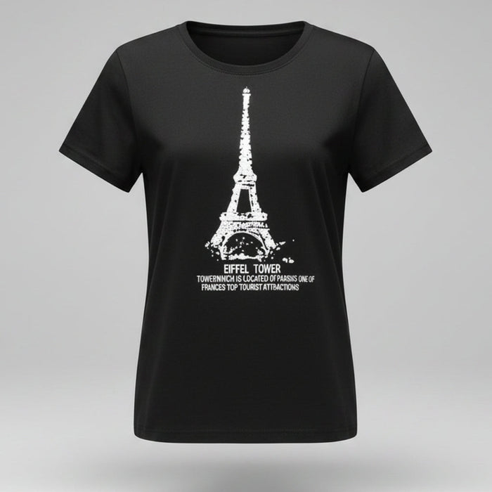 Person wearing a black t-shirt with Eiffel Tower design, sitting on the floor.