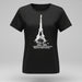 Person wearing a black t-shirt with Eiffel Tower design, sitting on the floor.