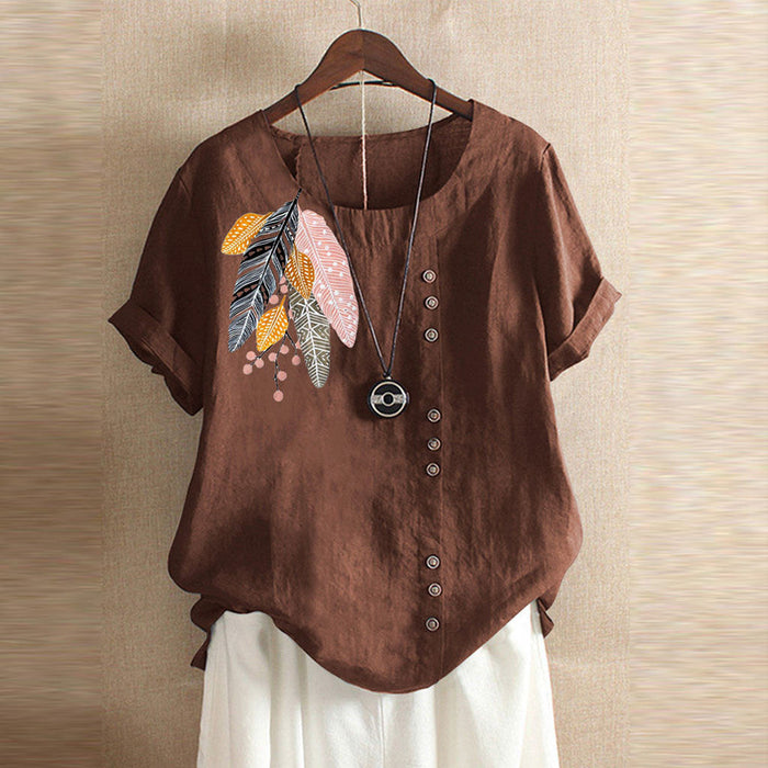 Brown blouse with feather design on a hanger against a beige wall