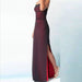 Burgundy strapless gown with a high slit on a light blue background