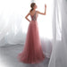 Pink evening gown with beaded back in a softly lit room